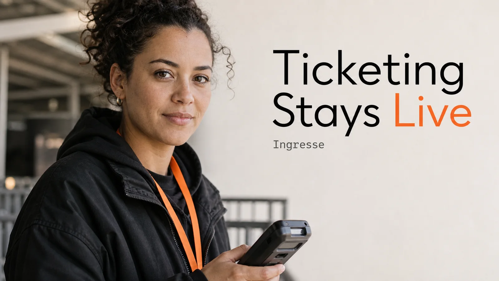 A ticketing operations professional holding a handheld scanner at an event venue entrance